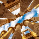 low angle photography of brown concrete building under blue sky during daytime